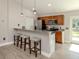 Modern kitchen with breakfast bar, stainless steel appliances, and an adjacent dining area at 6497 Honeycomb Cir, North Port, FL 34291