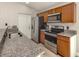 Updated kitchen with stainless steel appliances, granite countertops, and wood cabinets at 6497 Honeycomb Cir, North Port, FL 34291