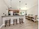 Modern kitchen featuring granite countertops, stainless steel appliances, and barstool seating at 6497 Honeycomb Cir, North Port, FL 34291