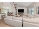 Open-concept living room showcasing a sectional sofa, media center, and seamless flow to dining at 6497 Honeycomb Cir, North Port, FL 34291