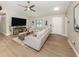 Bright living room featuring a comfortable sectional sofa, ceiling fan, and modern décor at 6497 Honeycomb Cir, North Port, FL 34291