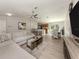 Open-concept living space with a large sectional, barstool seating, and a modern kitchen at 6497 Honeycomb Cir, North Port, FL 34291