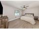 Cozy bedroom with a ceiling fan, wood-look flooring, and a neutral color palette at 6497 Honeycomb Cir, North Port, FL 34291