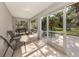 Enclosed screened porch features plenty of sunlight and a view to the backyard at 6497 Honeycomb Cir, North Port, FL 34291