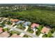 An aerial view showcases the home among other residential properties surrounded by lush green trees at 678 Clear Creek Dr, Osprey, FL 34229