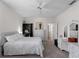 This simple, clean bedroom features a queen bed, neutral carpet and paint, and an en-suite bath at 678 Clear Creek Dr, Osprey, FL 34229