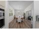 Formal dining area with a large window, an adjacent kitchen, and an open-concept layout at 678 Clear Creek Dr, Osprey, FL 34229