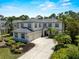 Stunning two-story home featuring a gray tile roof, two-car garage, and meticulously landscaped front yard at 678 Clear Creek Dr, Osprey, FL 34229