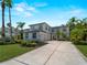 Stunning two-story home featuring a gray tile roof, two-car garage, and meticulously landscaped front yard at 678 Clear Creek Dr, Osprey, FL 34229