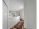 Bright hallway with wood floors and area rugs leads to the rest of the home's living spaces at 678 Clear Creek Dr, Osprey, FL 34229