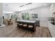 Open concept kitchen with a center island, natural light, and view into dining area and backyard at 678 Clear Creek Dr, Osprey, FL 34229
