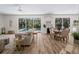 Bright living room with a view of the pool area, bar, and table and chairs, creating an inviting atmosphere at 678 Clear Creek Dr, Osprey, FL 34229