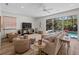 Spacious living room with views of the pool, a ceiling fan, and ample seating for relaxation at 678 Clear Creek Dr, Osprey, FL 34229