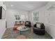 Inviting living room with neutral tones, swivel chairs, leading into a bright dining space at 678 Clear Creek Dr, Osprey, FL 34229