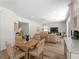 Bright living room with a dining table and views to the staircase and neutral decor at 678 Clear Creek Dr, Osprey, FL 34229