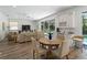 Bright and open living room area with views of the pool and access to dining space and custom bar at 678 Clear Creek Dr, Osprey, FL 34229