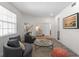 Cozy living room with swivel chairs, a glass coffee table, and soft textures over wood flooring at 678 Clear Creek Dr, Osprey, FL 34229