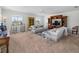 The open living room is bright and has neutral carpeting and a ceiling fan at 678 Clear Creek Dr, Osprey, FL 34229