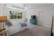 Bright bedroom with view from window, features modern ceiling fan, blue dresser, and neutral tones at 678 Clear Creek Dr, Osprey, FL 34229