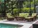 This screened-in lanai features comfortable patio furniture and an in-ground swimming pool at 678 Clear Creek Dr, Osprey, FL 34229