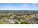 Expansive aerial view showcasing the neighborhood, the surrounding trees, and ocean view at 755 Mohawk Rd, Venice, FL 34293
