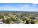 Panoramic aerial view of residential neighborhood by the ocean with lush green trees and blue skies at 755 Mohawk Rd, Venice, FL 34293