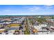 Breathtaking aerial view of a vibrant city street lined with palm trees, buildings, and the ocean in the distance at 755 Mohawk Rd, Venice, FL 34293