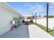 Spacious backyard patio with outdoor seating, string lights, and white fence at 755 Mohawk Rd, Venice, FL 34293