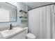 Stylish bathroom featuring a granite countertop, black accents, and a shower with curtain at 755 Mohawk Rd, Venice, FL 34293