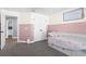 Comfortable bedroom featuring a day bed, soft carpet, and paneled walls at 755 Mohawk Rd, Venice, FL 34293