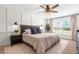 Calm bedroom features a ceiling fan, natural light, and decorative wall paneling for a cozy feel at 755 Mohawk Rd, Venice, FL 34293