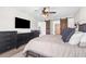 Comfortable bedroom includes stylish ceiling fan and barn door detail to living area at 755 Mohawk Rd, Venice, FL 34293