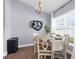 Bright dining area with wood floors, chandelier, large window, and contemporary art at 755 Mohawk Rd, Venice, FL 34293