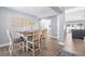 Inviting dining room with wood-look tile flooring that leads to an open-concept living space at 755 Mohawk Rd, Venice, FL 34293