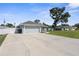 Home with a grey exterior, attached two-car garage and a long concrete driveway at 755 Mohawk Rd, Venice, FL 34293