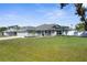 Well-maintained house with a green lawn, front porch and grey exterior paint at 755 Mohawk Rd, Venice, FL 34293