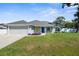 Charming single-story home with a well-manicured lawn, blue door, and inviting curb appeal at 755 Mohawk Rd, Venice, FL 34293