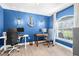 Comfortable home office featuring blue walls, wall sconces, and tile flooring at 755 Mohawk Rd, Venice, FL 34293