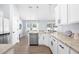 Modern kitchen with white cabinetry, stainless steel appliances, and granite countertops at 755 Mohawk Rd, Venice, FL 34293