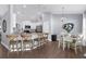 Beautiful open kitchen with stainless appliances, wood floors, and pendant lighting over breakfast bar at 755 Mohawk Rd, Venice, FL 34293