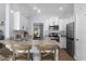 Modern kitchen with white cabinetry, stainless steel appliances, and a breakfast bar at 755 Mohawk Rd, Venice, FL 34293