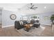 Cozy living room featuring a large sectional sofa, neutral colors, and wood-look tile flooring at 755 Mohawk Rd, Venice, FL 34293