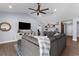 Spacious living room with stylish furnishings, including a large sectional and custom shelves at 755 Mohawk Rd, Venice, FL 34293