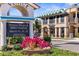 Street view of Century 21 office, signage for the Venice Blues & BBQ Festival, with planter of bright flowers at 755 Mohawk Rd, Venice, FL 34293