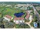 Aerial view showcasing the community's lush landscaping, serene pond, and convenient parking at 821 Waterside Dr # 106, Venice, FL 34285