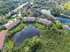 Community aerial showcasing the pond and mature landscaping at 821 Waterside Dr # 106, Venice, FL 34285