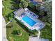Overhead view of the community pool surrounded by lush greenery and comfortable lounging areas at 821 Waterside Dr # 106, Venice, FL 34285