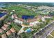 Beautiful aerial view of the complex, highlighting the pond and mature landscaping at 821 Waterside Dr # 106, Venice, FL 34285