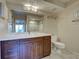 Bathroom with wood vanity, granite countertop, decorative lighting, and tile flooring at 821 Waterside Dr # 106, Venice, FL 34285