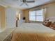 Bright bedroom showcases a comfortable bed, soft carpet, and large window at 821 Waterside Dr # 106, Venice, FL 34285